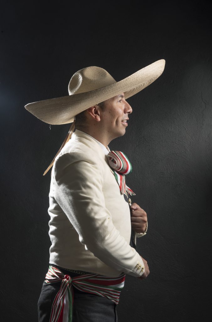 a man wearing a sombrero and a white shirt